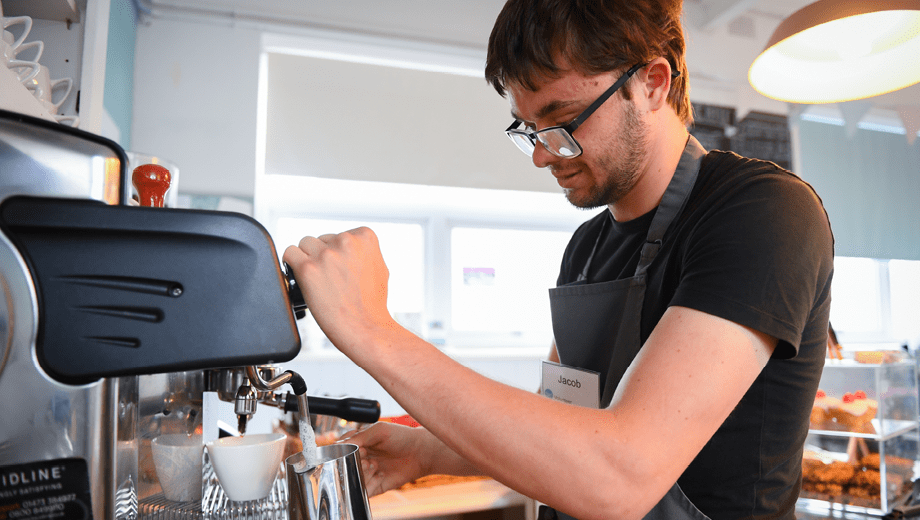 SEND student making a coffee as part of his vocational course